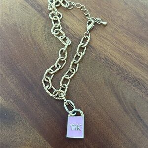 Michael Kors Gold tone bracelet with Pink Pendant